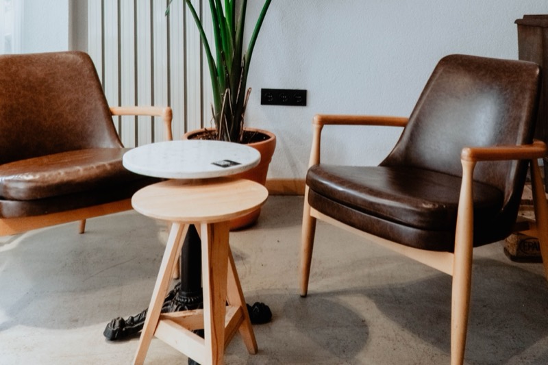 Two armchairs turned towards a small table, set for a one-to-one conversation.