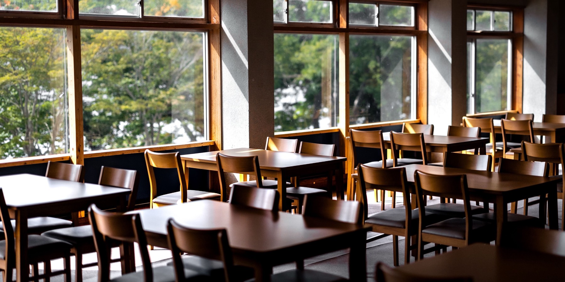A light-filled room set with tables and chairs, ready for a session.