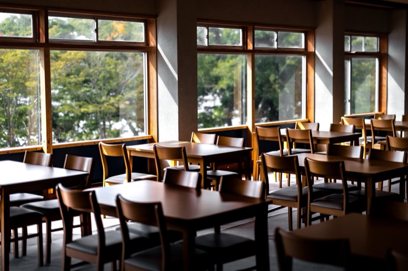 A light-filled room set with tables and chairs, ready for a session.